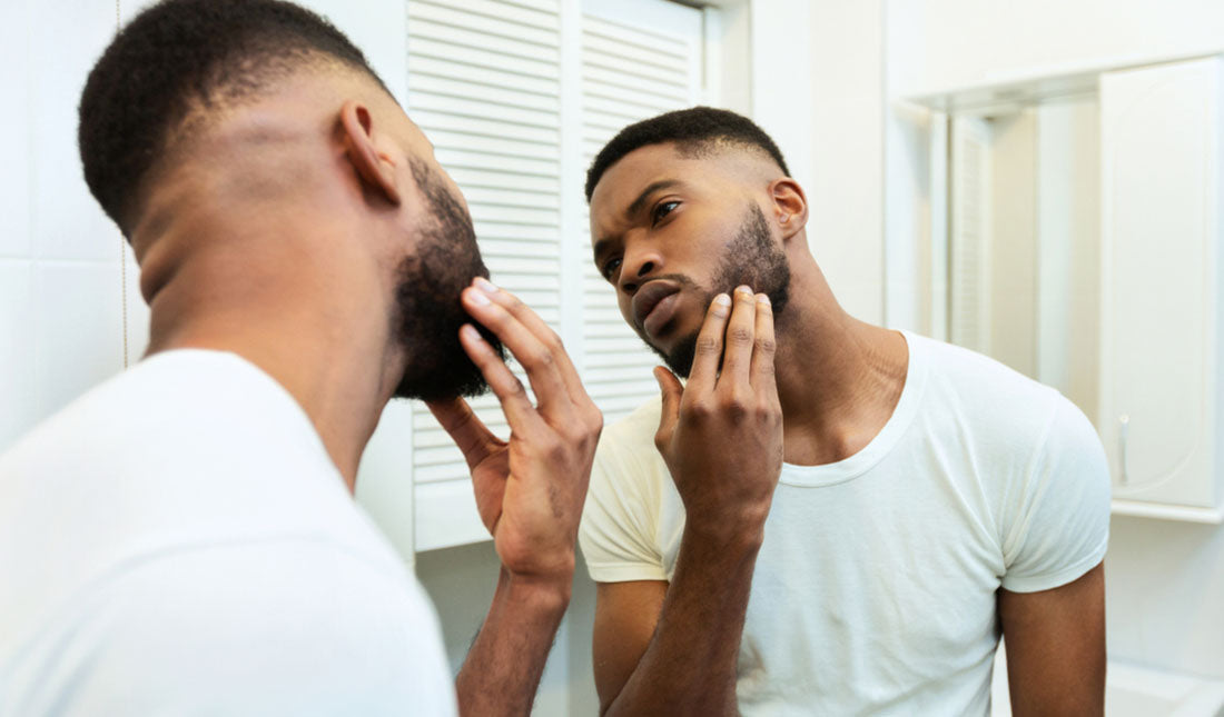 man checking facial stubble