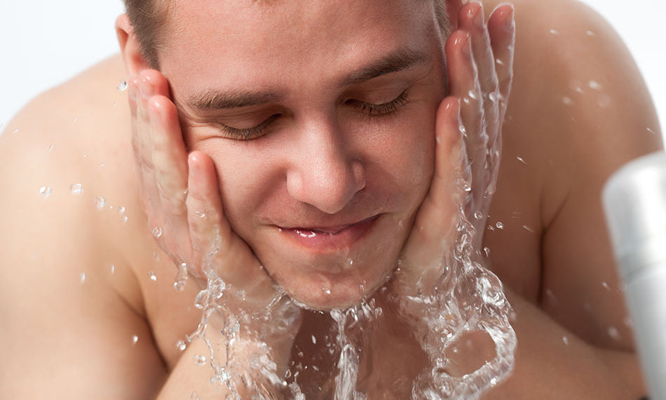 man washing face