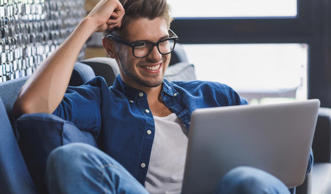 smiling man on laptop