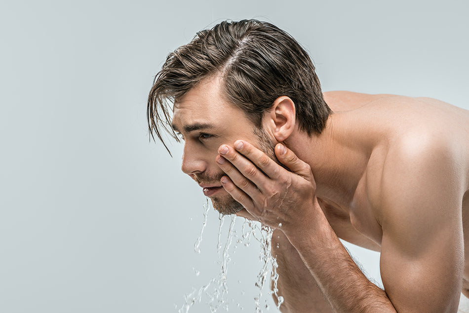 man washing face