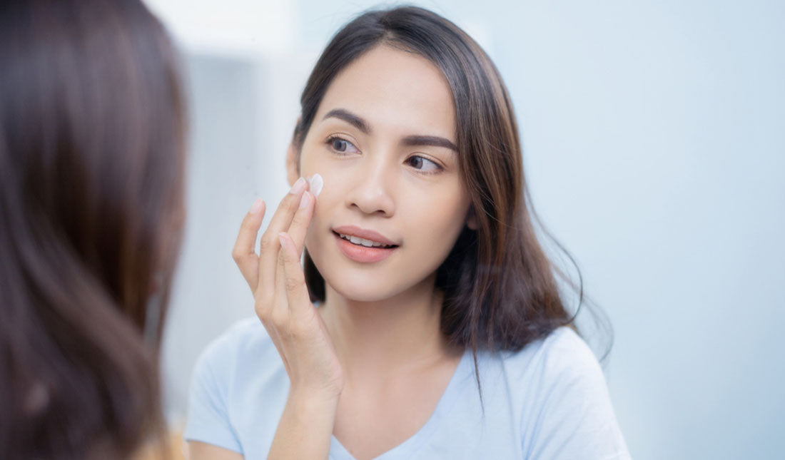 woman applying facial cream